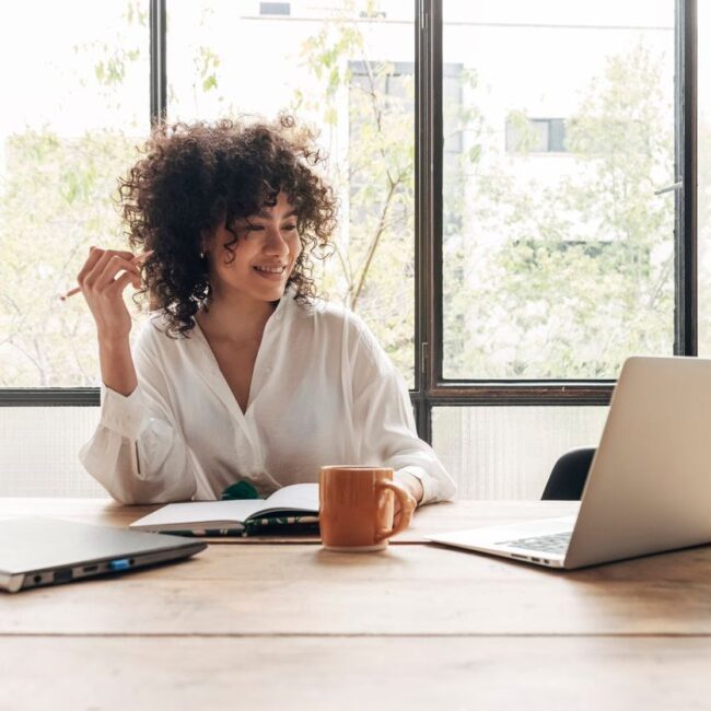 Beautiful woman attending online learning class from home office